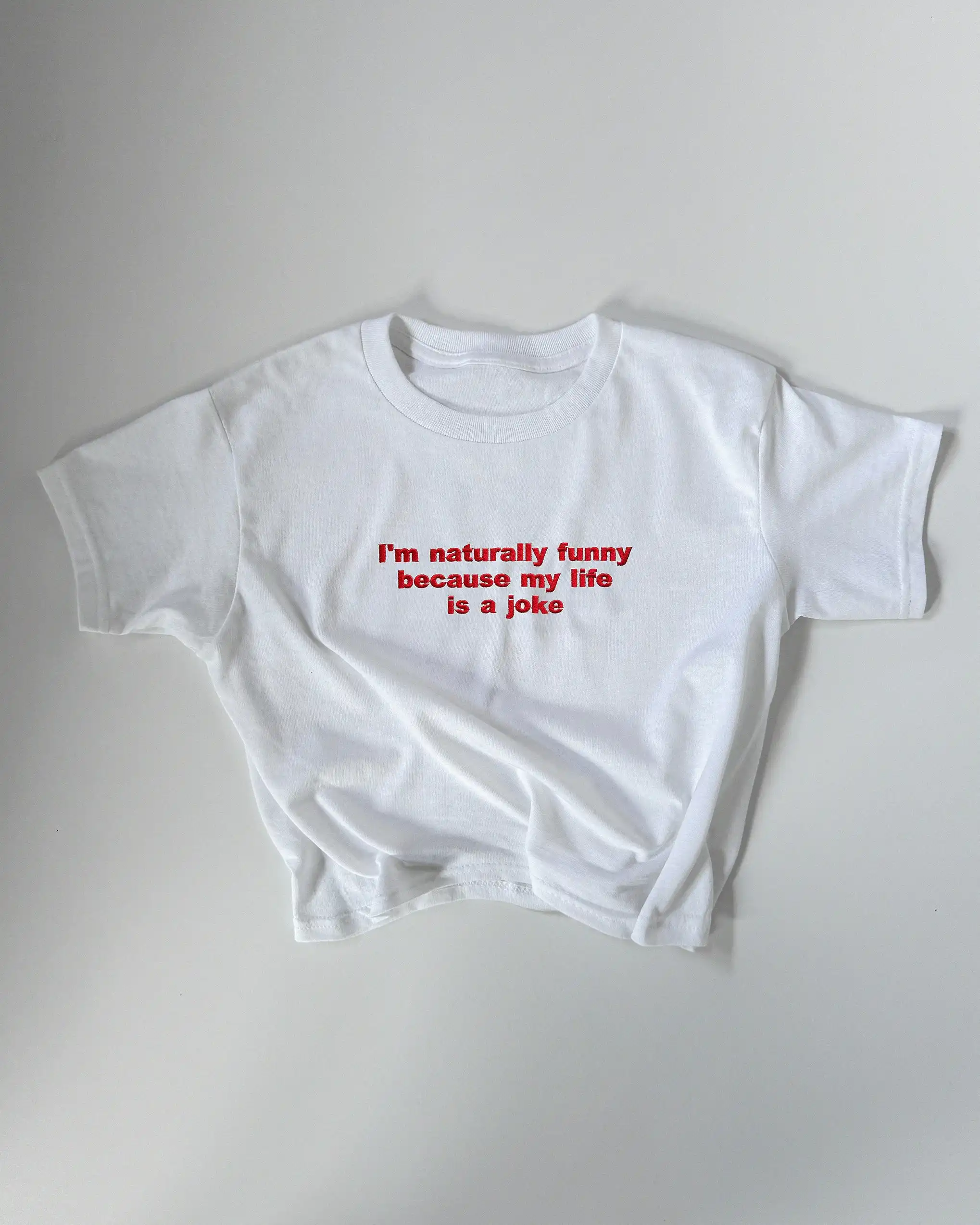 Embroidered ‘I’m Naturally Funny Because My Life is a Joke’ T-Shirt - Baby & Regular Fit Embroidered ‘I’m Naturally Funny Because My Life is a Joke’ T-Shirt - Baby & Regular Fit